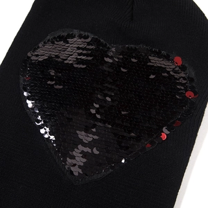 Women's black knit beanie featuring a flip sequin heart design for winter warmth