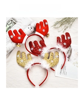 Detailed view of plush red and sequined reindeer headbands with festive bells and feathers