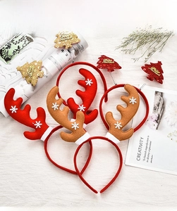 Detail of Christmas reindeer antler headbands with snowflakes and Feliz Navidad tree