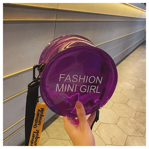 Detail of round purple jelly bag with Fashion Mini Girl text and yellow strap