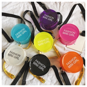 Overhead view of colorful circular transparent PVC crossbody bags for girls in seven vibrant hues