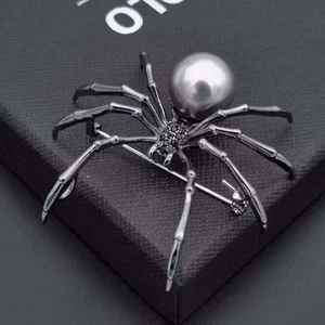 Spider brooch with dark grey pearl and black zircons on luxury leather jewelry box