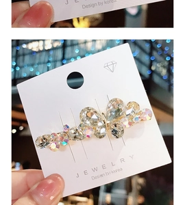 Macro detail of butterfly hair clip with colorful crystals and sparkling rhinestones