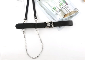 Detail of punk black leather body harness with silver rings and detachable metal chains