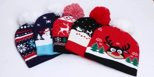 Detail view of various Christmas knit beanies featuring reindeer and snowflake patterns