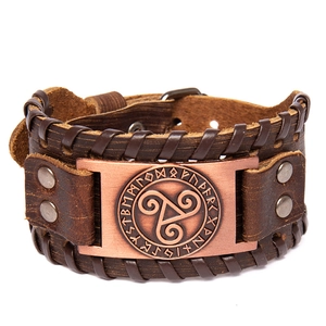 Nordic Viking rune wide leather bracelet with bronze Triskelion metal plate on white background