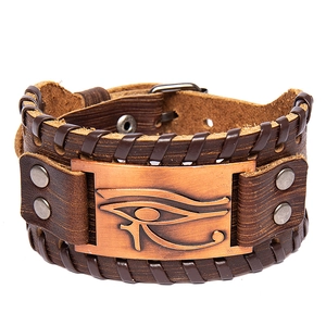 Vintage Viking leather bracelet with bronze Eye of Horus plate on white background
