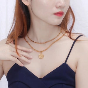 Layered gold coin necklace with embossed queen pendant and chunky chain for women