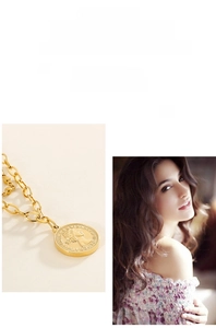 Close-up of double-layered gold coin necklace with vintage portrait embossed pendant