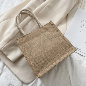 Detail of eco-friendly jute tote bag featuring sturdy woven rope handles and natural texture