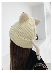 Rear view of cream white knitted beanie with cute cat ears and small tail detail