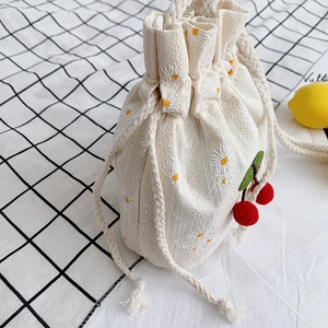 Cute cherry canvas bucket bag with daisy embroidery and plush red pompom pendant