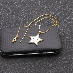 Star pendant necklace with mother of pearl and colorful gems on a black jewelry box