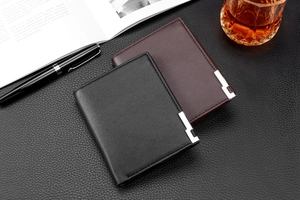 Business style black and brown leather wallets shown with pen and book in office setting