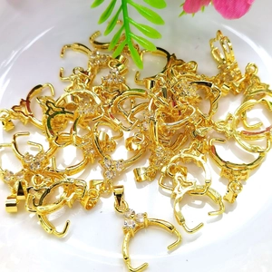 Bulk 14K gold plated pendant clasps with cubic zirconia on a white plate