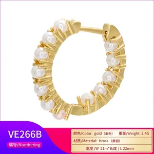 Gold plated brass hoop earrings with micro-set pearls measuring 21mm by 22mm