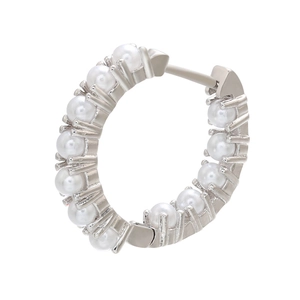 Macro shot of silver C-shaped hoop earrings with micro-paved white round pearls