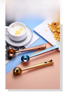 Close-up of dual-function stainless steel measuring spoon with built-in sealing clip