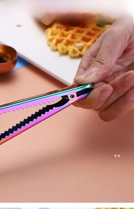 Close-up of rainbow stainless steel food clip with serrated teeth and thickened spring
