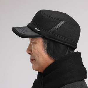 Detail of warm winter flat cap for men featuring foldable earflaps and sport logo