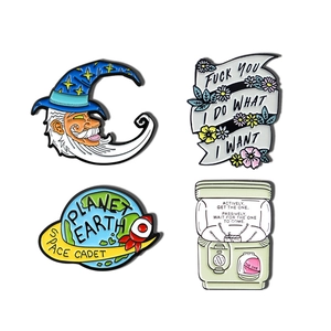 Set of four creative enamel pins featuring moon wizard, planet earth, and colorful badges