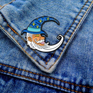 Wizard moon enamel pin featured on a blue denim jacket pocket showing detailed craft
