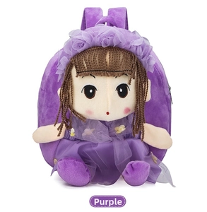 Close-up of a purple plush children's backpack featuring a 3D doll with mesh tutu and flowers