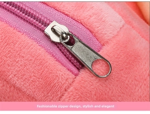 Close-up of a smooth silver metal zipper on a pink plush cartoon backpack for kids