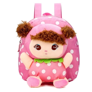 Close-up of kids pink polka dot canvas backpack with a 3D plush doll decoration