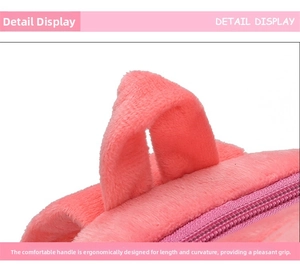 Detailed close-up of pink plush backpack showing ergonomic top handle and smooth zipper