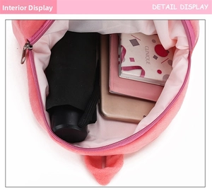 Interior view of kids cartoon plush backpack showing storage for phone and umbrella