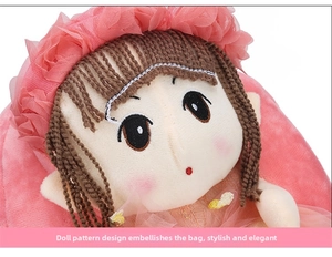 Detailed close-up of cute pink plush backpack with a cartoon doll face and lace trim decoration