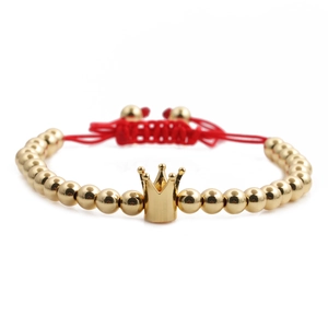 Handmade red braided crown bracelet with gold metal beads on a clean white background