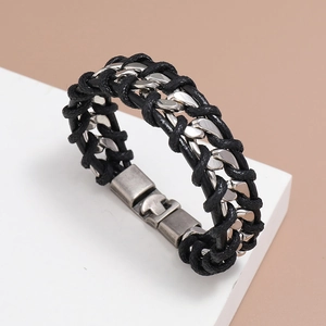 Detail of black braided leather strap and silver metal chain with vintage style buckle