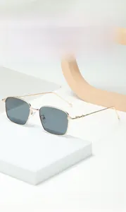Detailed shot of golden metal square sunglasses with stylish geometric temple design