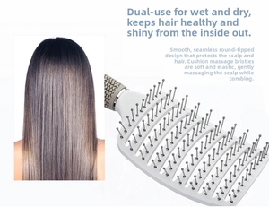 Dettaglio spazzola per capelli curva bianca con setole arrotondate per massaggio cute