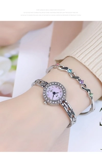 Close-up of women's silver quartz watch with crystal bezel and multi-color gem bracelet