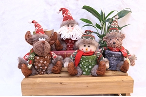 Christmas plush gift boxes featuring Santa, Reindeer, Snowman, and Bear on wood base