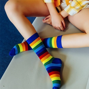 Rainbow striped high socks for women and men, featuring vibrant multicolor cotton fabric