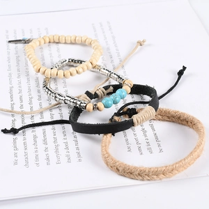 Multilayer leather bracelet set with turquoise beads and feather pendants on paper