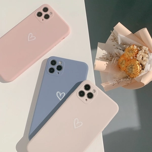 Detail of matte heart pattern iPhone cases in soft pink, blue, and cream white colors