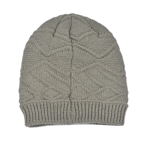 Macro detail of grey knit beanie featuring geometric diamond pattern and ribbed cuff