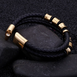 Men's double-layer braided leather bracelet with gold metal hardware on grey stone