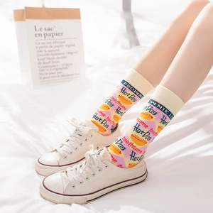Women's cream cotton mid-calf socks with pink argyle patterns and cute hot dog graphics