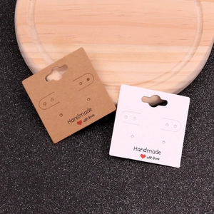 Close-up of brown and white square earring display cards with Handmade with love print