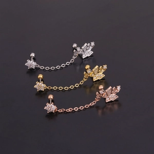 Detail of silver, gold, and rose gold chain earrings with butterfly and star charms