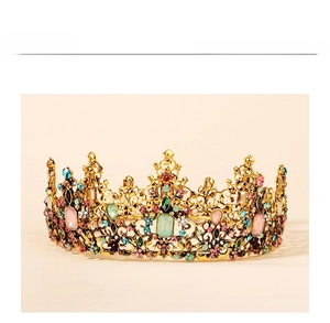 Detailed shot of Baroque golden crown featuring colorful rhinestones and floral hollow carvings