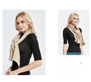 Detail of beige hollow knit triangle scarf showing soft wool texture and drape effect