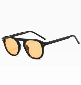 Detailed close-up showing black thick frame with orange lenses and silver rivet accents