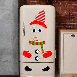 Close-up of DIY snowman magnetic fridge stickers on a vintage kitchen refrigerator